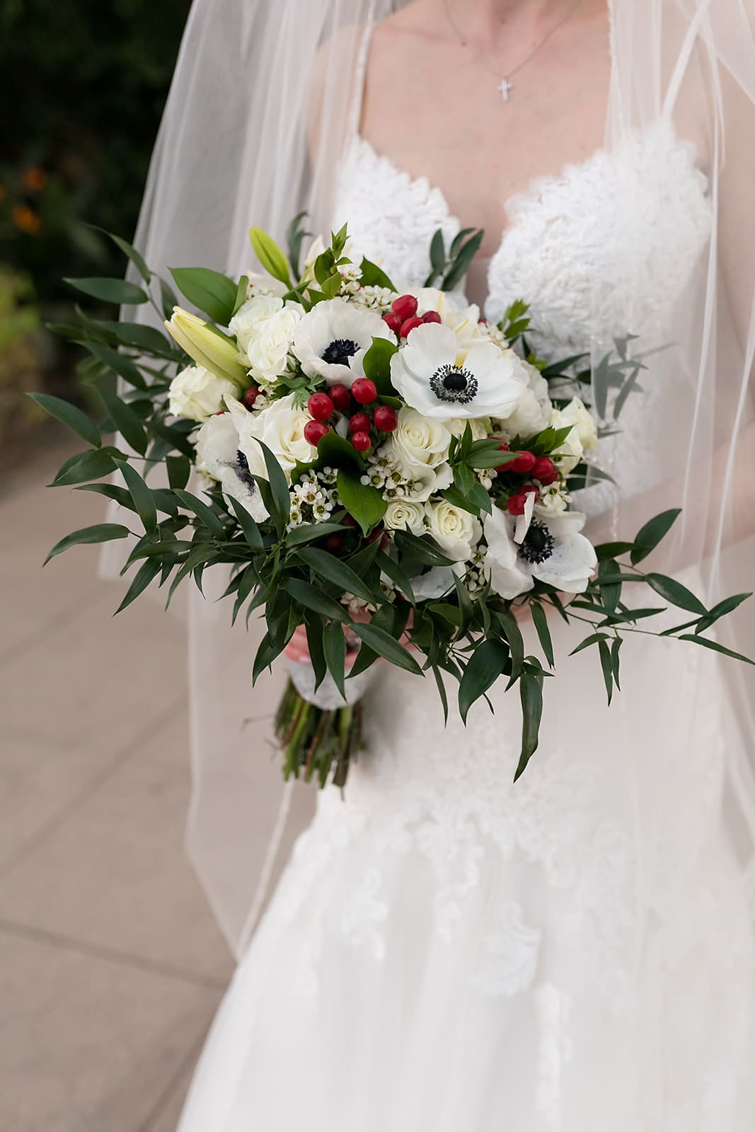 Bride and groom with floral bouquet