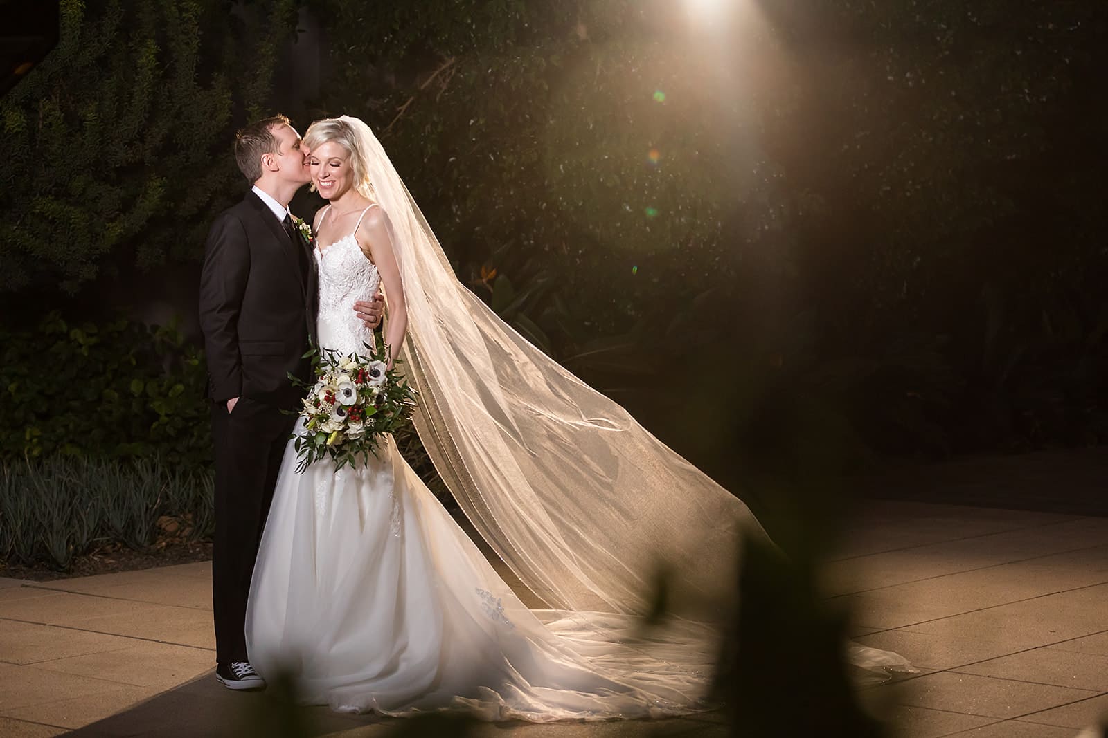 Bride and groom with floral bouquet